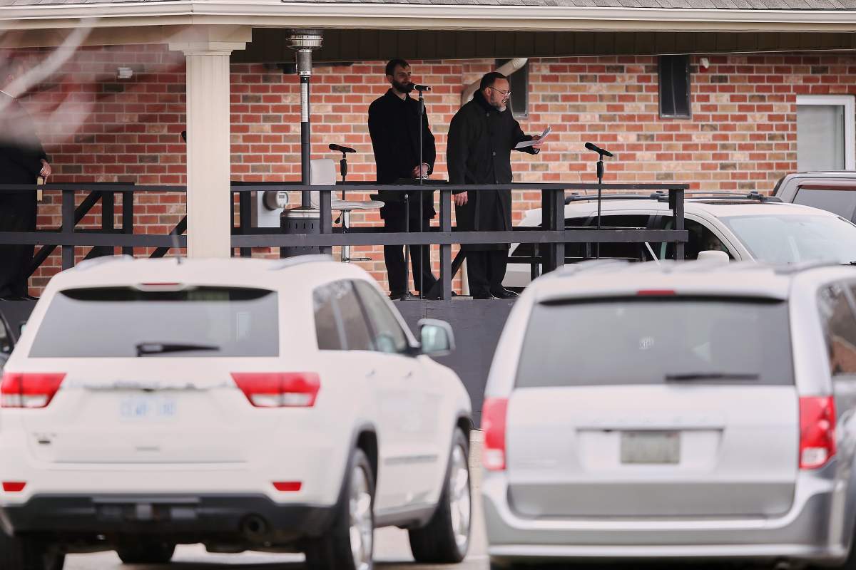 FILE - Pastor Henry Hildebrandt speaks during a drive-in Sunday service at The Church of God in Aylmer, Ont. on Sunday, April 26, 2020.