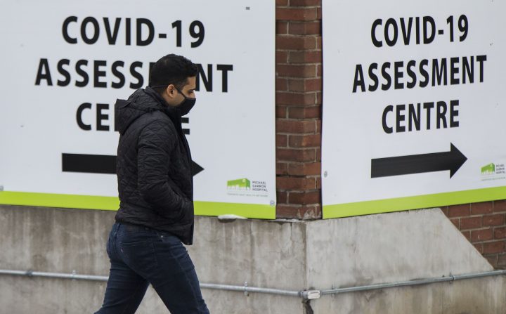 FILE -- A man wearing a face mask arrives at a COVID-19 assessment center in Toronto, Ontario, Canada, Dec. 27, 2020.