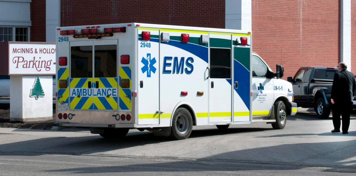 An ambulance arrives after a mourner collapsed at the funeral for Jordan Segura, one of the victims of an April 15 mass stabbing attack, in Calgary on Monday, April 21, 2014. 