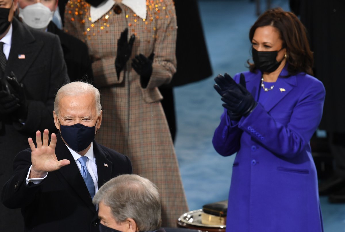 US Vice President-Kamala Harris aplauds as US President Joe Biden waves ahead of the inauguration of Joe Biden as the 46th US President on January 20, 2021, at the US Capitol in Washington, DC.