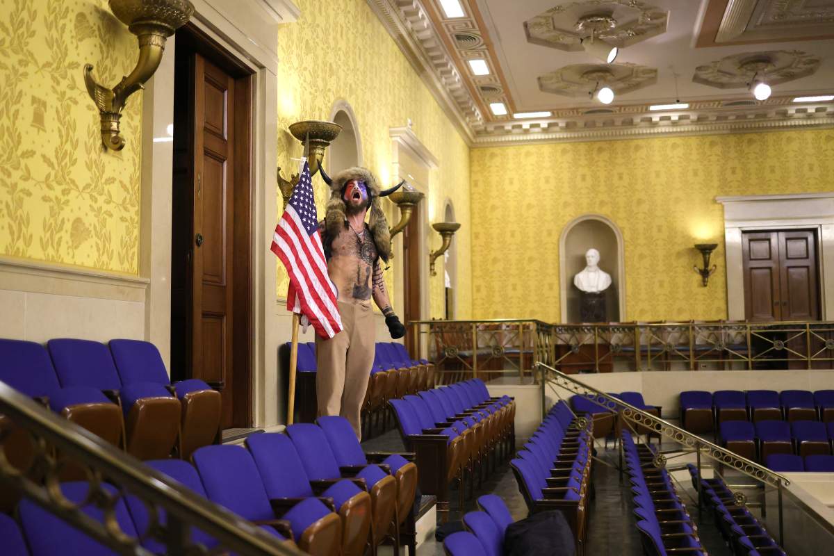 A protester screams ‘Freedom’ inside the Senate chamber after the U.S. Capitol was breached by a mob during a joint session of Congress on January 06, 2021 in Washington, DC. Congress held a joint session today to ratify President-elect Joe Biden’s 306-232 Electoral College win over President Donald Trump. (Photo by Win McNamee/Getty Images)