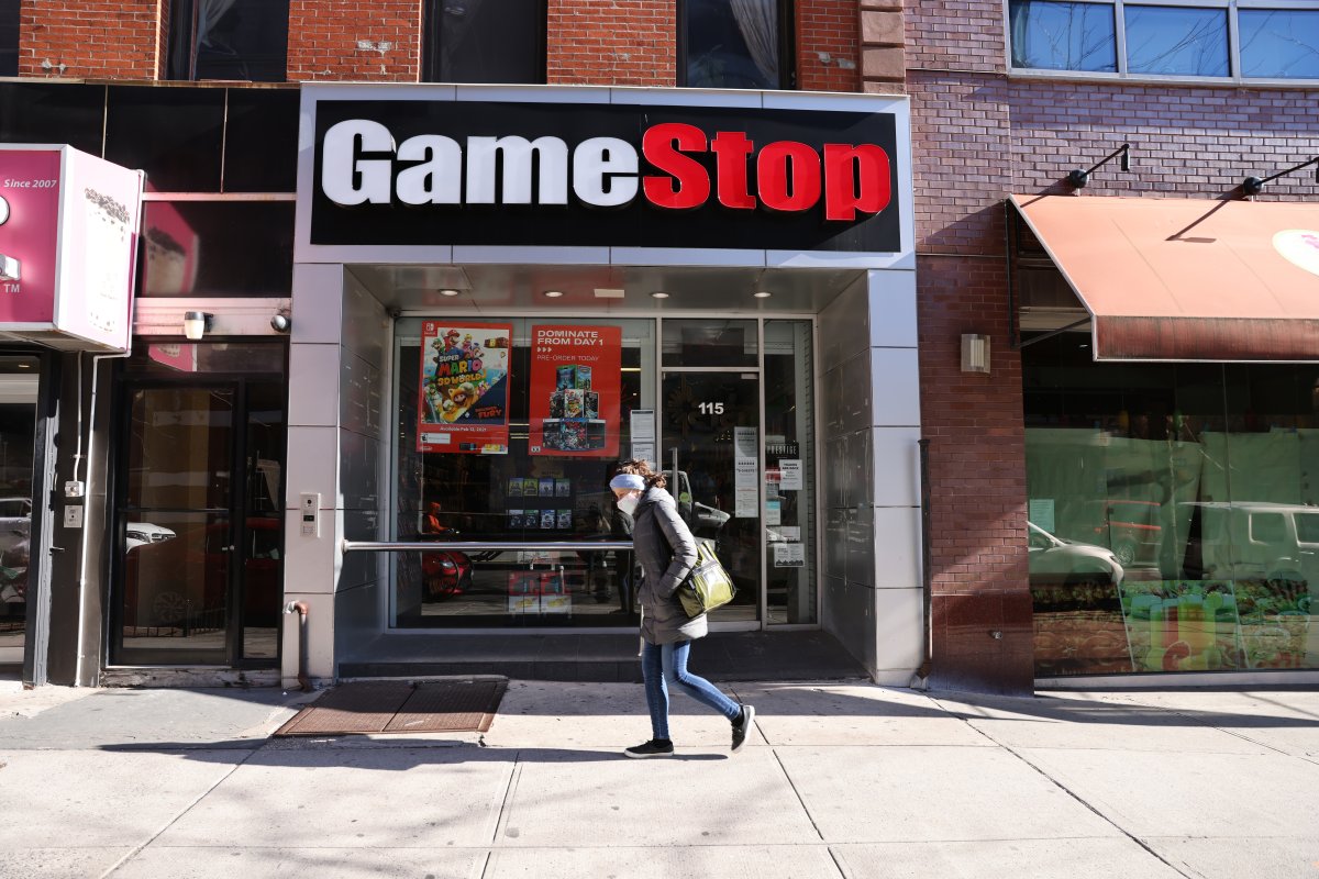 NEW YORK, NEW YORK - JANUARY 28: People walk by a GameStop store in Brooklyn on January 28, 2021 in New York City. Markets continue a volatile streak with the Dow Jones Industrial Average rising over 500 points in morning trading following yesterdays losses. Shares of the video game retailer GameStop plunged. (Photo by Spencer Platt/Getty Images).