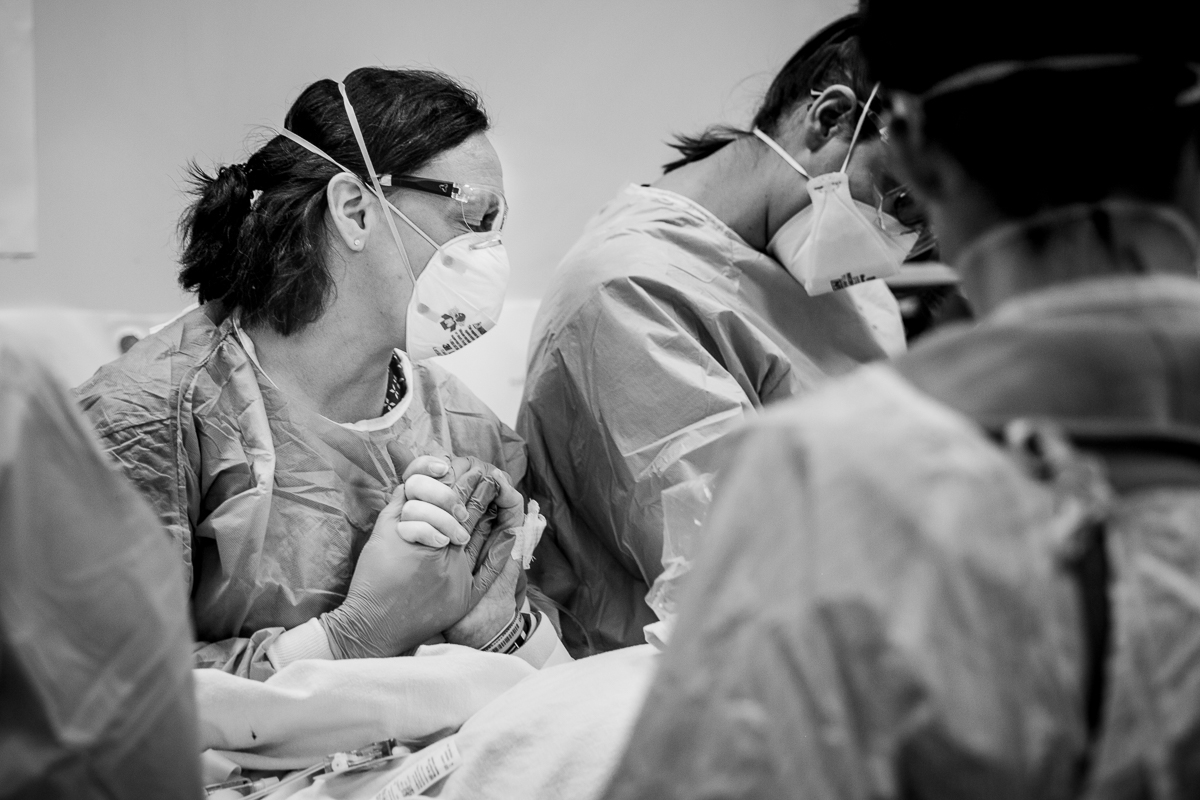 AHS worker holding hand of patient.