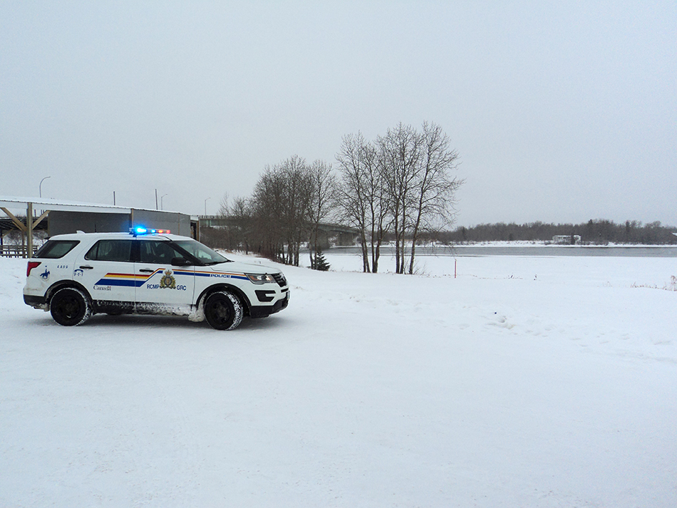 Grand Rapids RCMP at the scene where a man was rescued from the Saskatchewan River Wednesday.