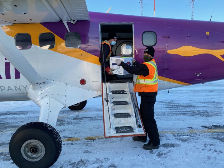 Workers unload vaccines at the La Ronge airport.