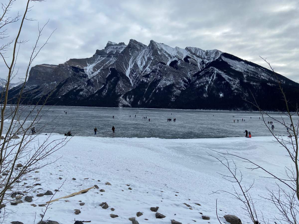 Visitors enjoy Lake Minnewanka near Banff, Alta., Sunday, Jan. 24, 2021.