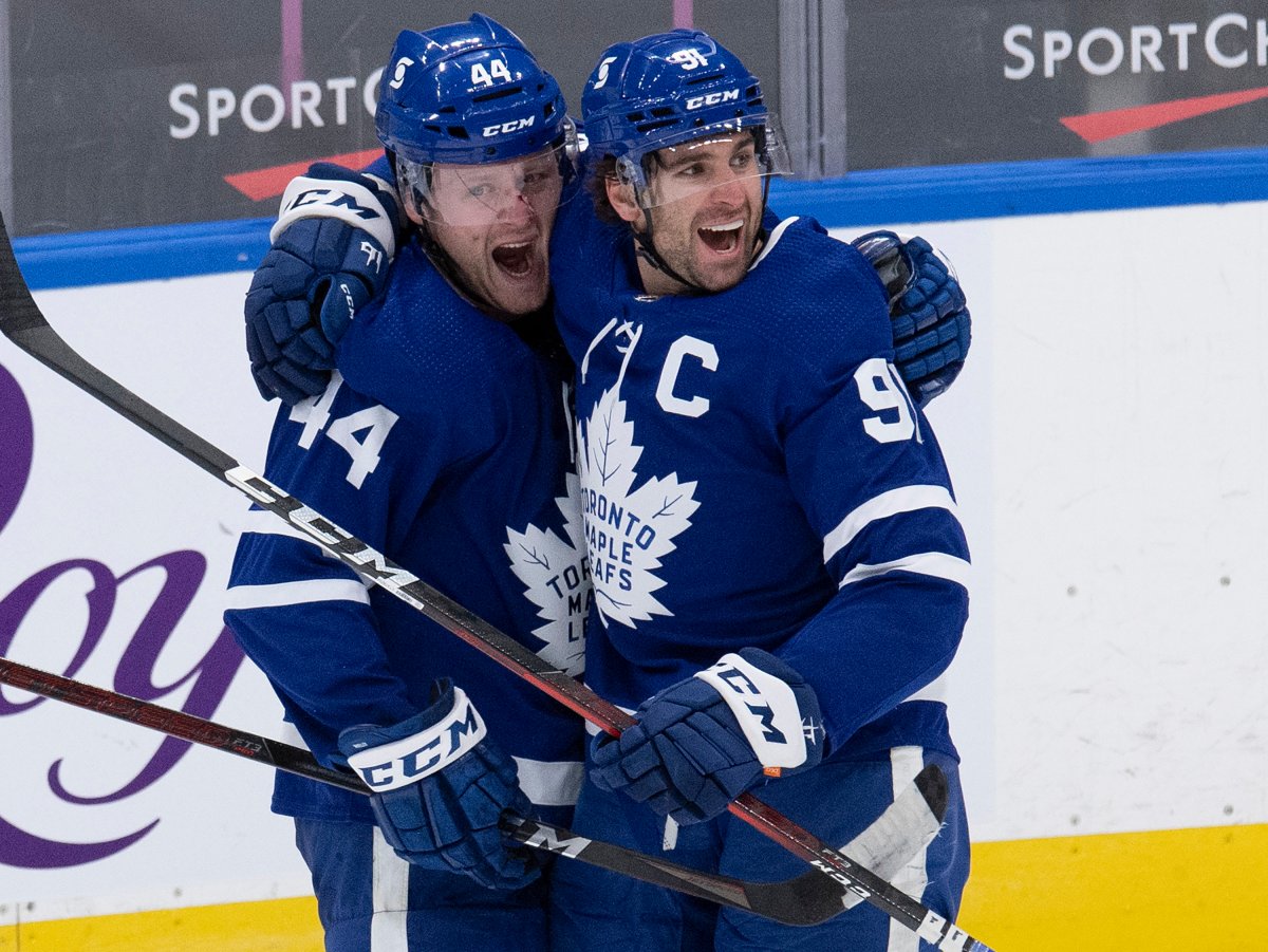 Toronto Maple Leafs defenceman Morgan Rielly (44) is congratulated by teammate John Tavares (91) on his game winning goal during overtime NHL action against the Montreal Canadiens, in Toronto, Wednesday, Jan. 13, 2021.
