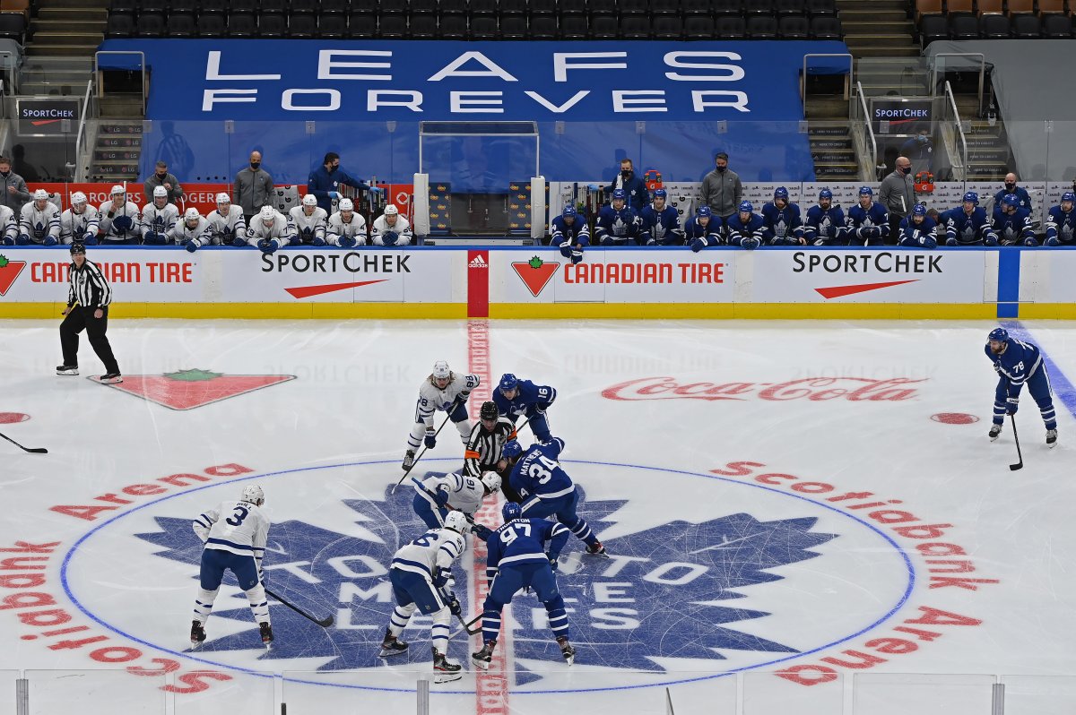 Toronto Maple Leafs players face off at the beginning of first period Blue versus White scrimmage action as part of training camp in Toronto on Saturday, January 9, 2021.