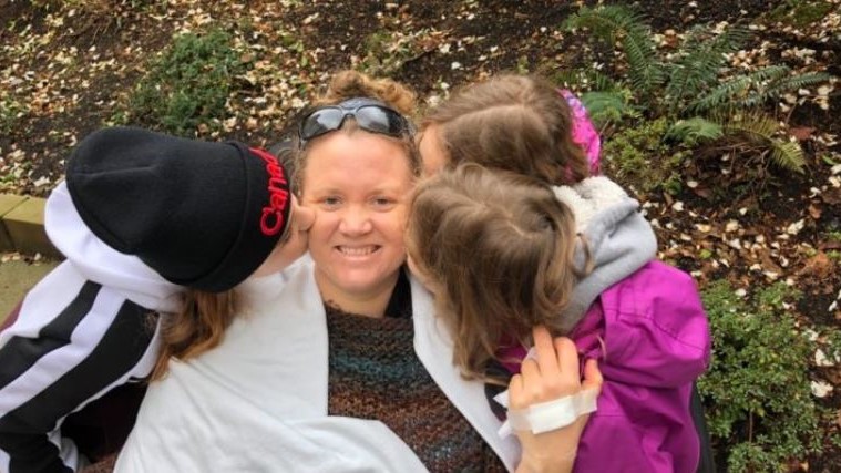 The fundraiser says Brita Colero, seen here surrounded by her daughters, is currently paraplegic, and, barring a miracle, will not regain the use of her legs.