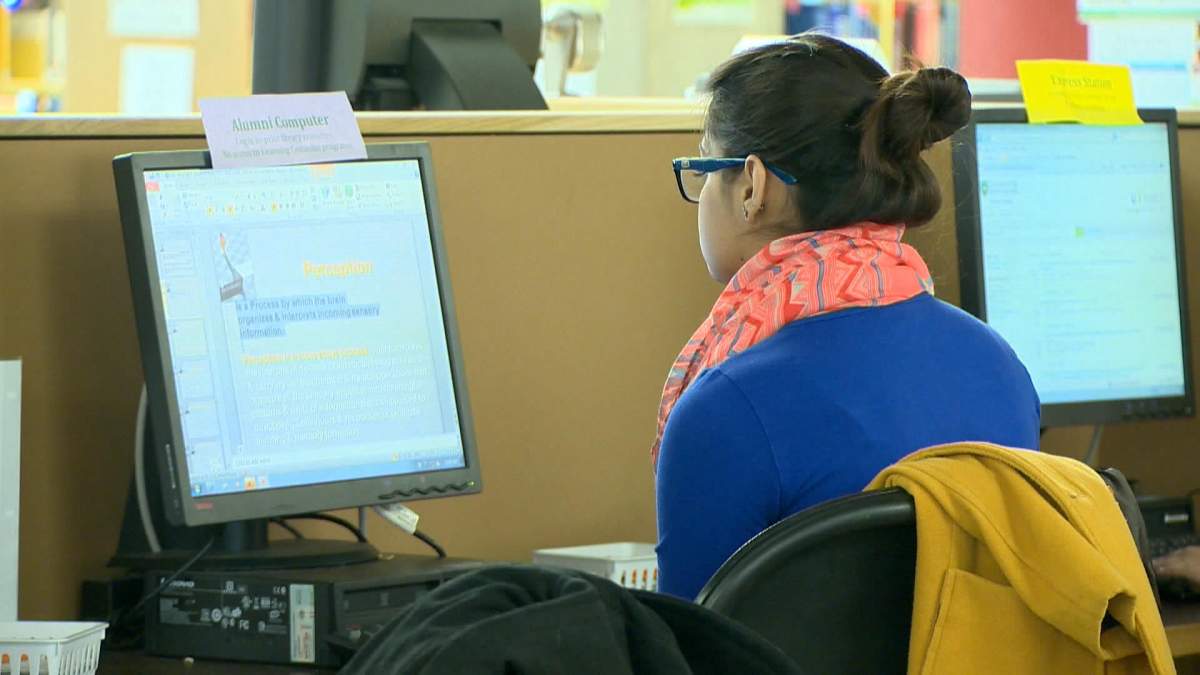 A USask student checking their computer.