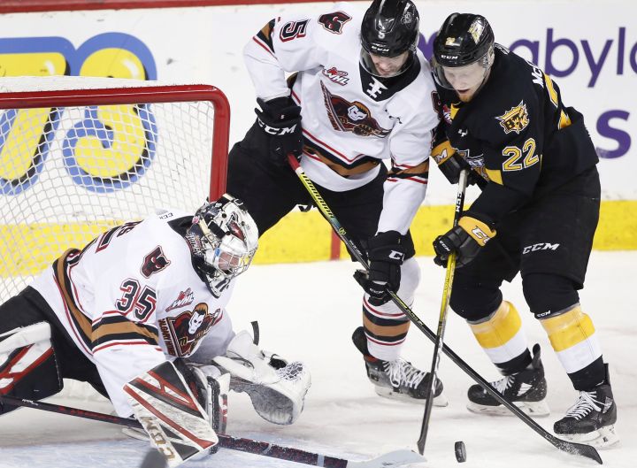Brandon Wheat Kings player Ben McCartney, right, has a shot stopped by Calgary Hitmen goalie Brayden Peters, left, during WHL (Western Hockey League) hockey action in Calgary, Alta., on Fri., Jan. 31, 2020. Center is Calgary player Jackson van de Leest. 