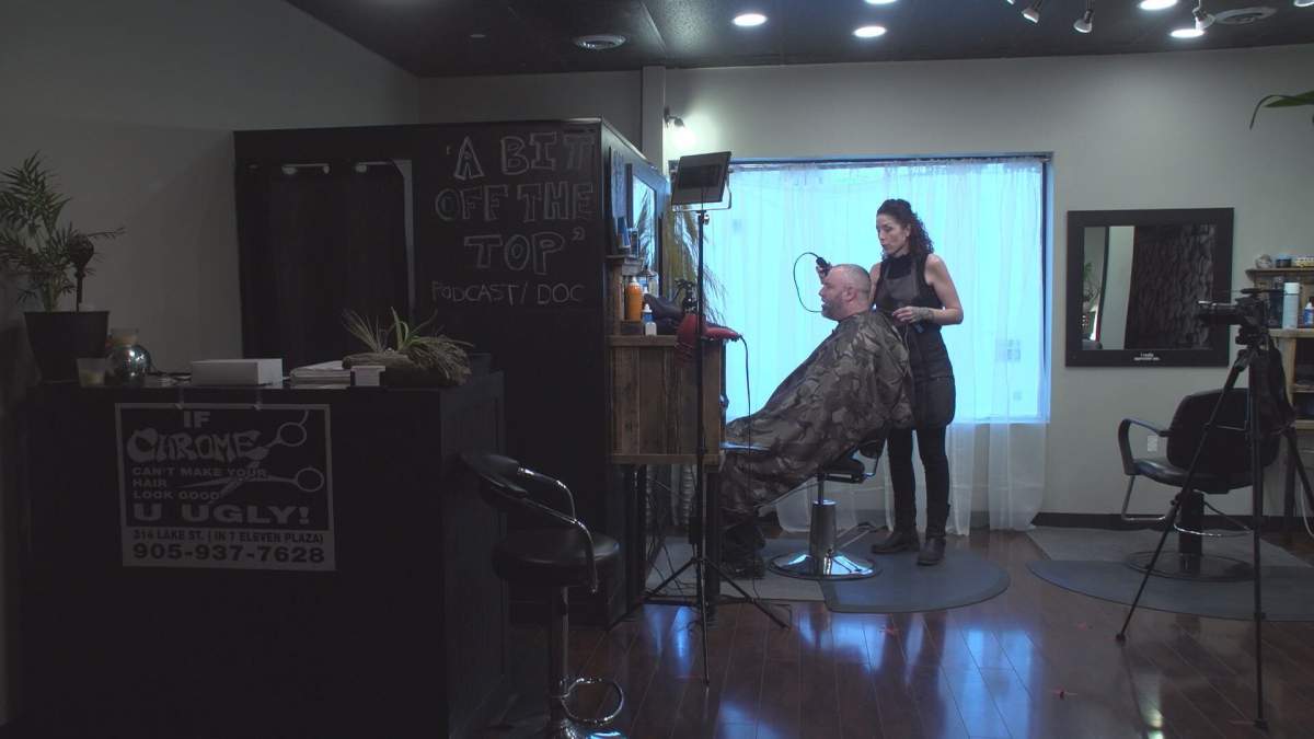 Alicia Hirter, owner of Chrome Artistic Barber, working at her salon in St.Catharines. Hirter's storefront now includes cameras, microphones and production lighting for auditions. The idea is to operate as a film or TV set, since those are exempt from Ontario’s lockdown rules.