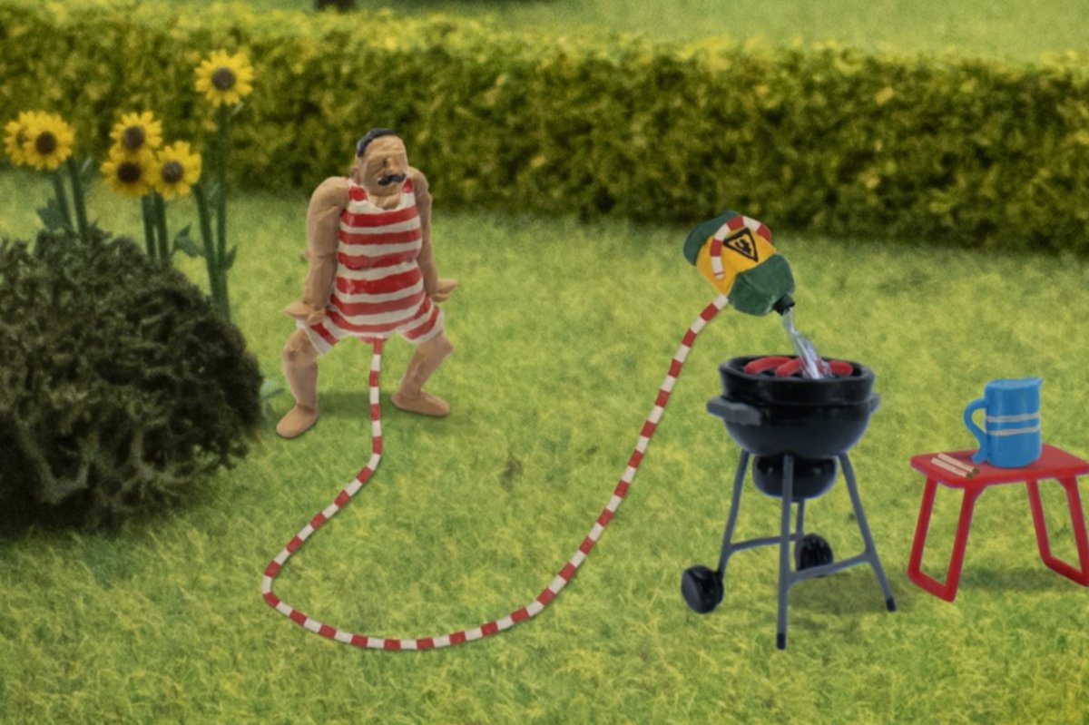 The main character from 'John Dillermand' uses his penis to start a barbecue in this image from the show.