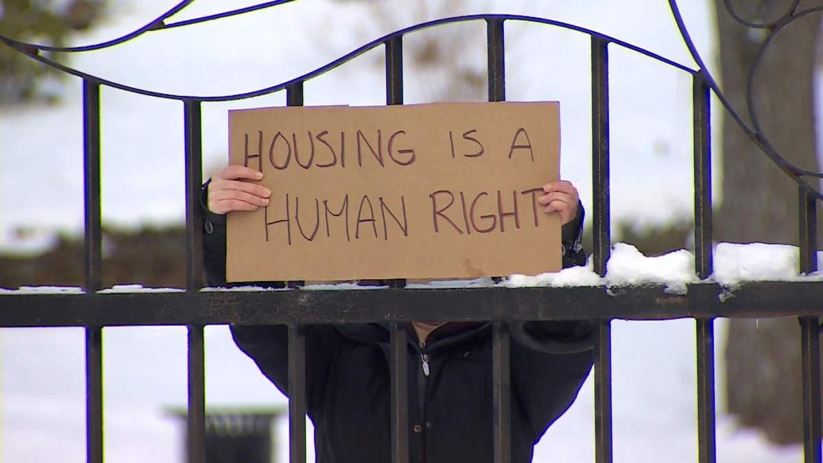 A protestor holds up a sign at a demonstration in Dartmouth on Monday January 25, 2021.