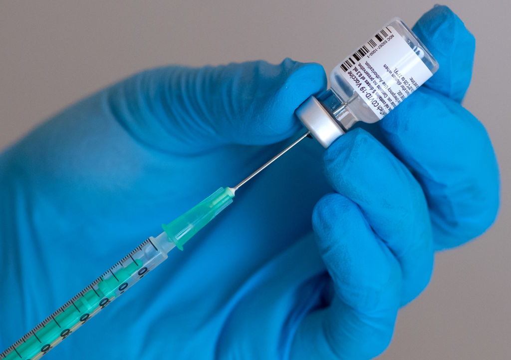 A dose of the Pfizer-BioNTech vaccine is prepared at a vaccination clinic.