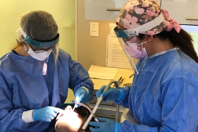 Dr. Natalie Archer and her colleague tend to a patient in Toronto on Jan. 21, 2021.