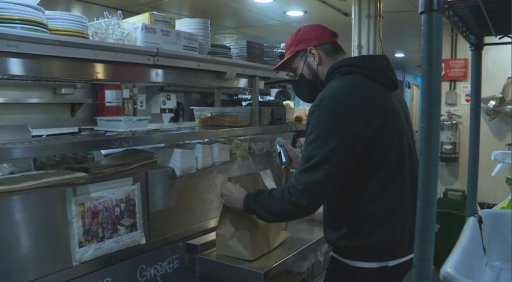 Staff at Battery Park prepare a take-out order