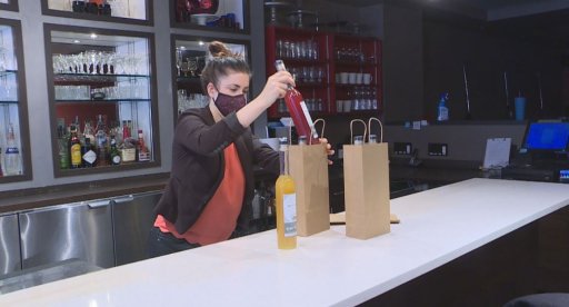 Lacey Doherty prepares a delivery order of cocktails from The Middle Spoon.