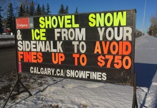 Sign on 52 Street north east in Calgary warns residents to clear their sidewalks.