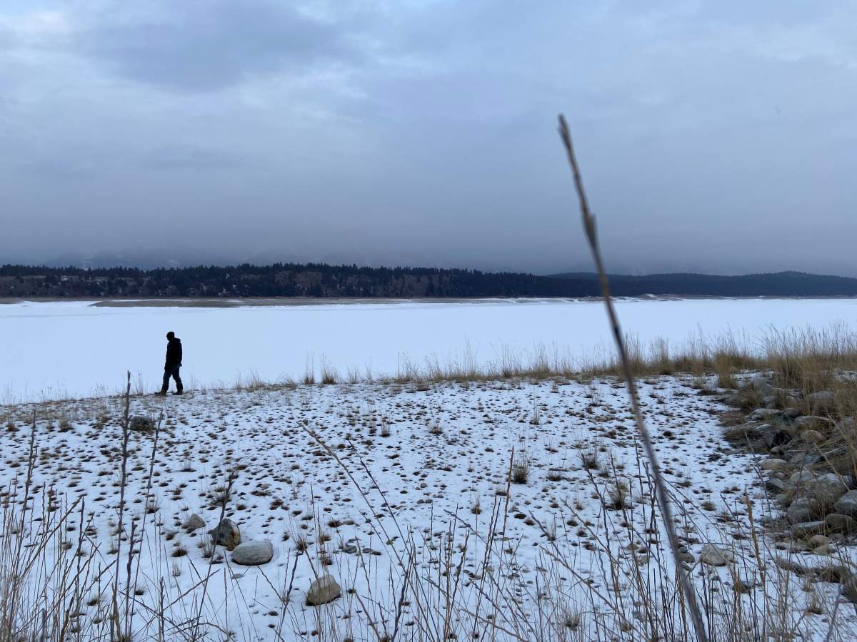 Lars Sander-Green walking along shores of Lake Koocanusa.