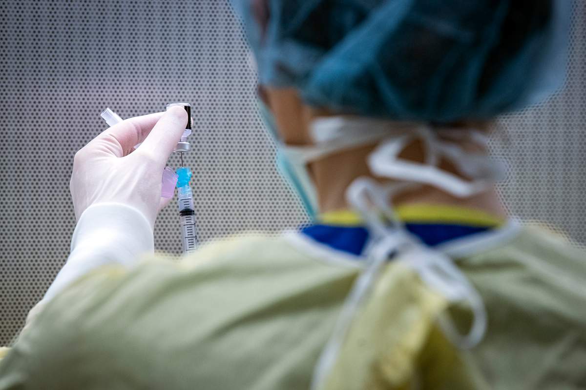 FILE - KINGSTON, ON - JANUARY 12: Pharmacy staff at Kingston Health Sciences Centre prepare doses of the Pfizer-BioNTech COVID-19 vaccine.