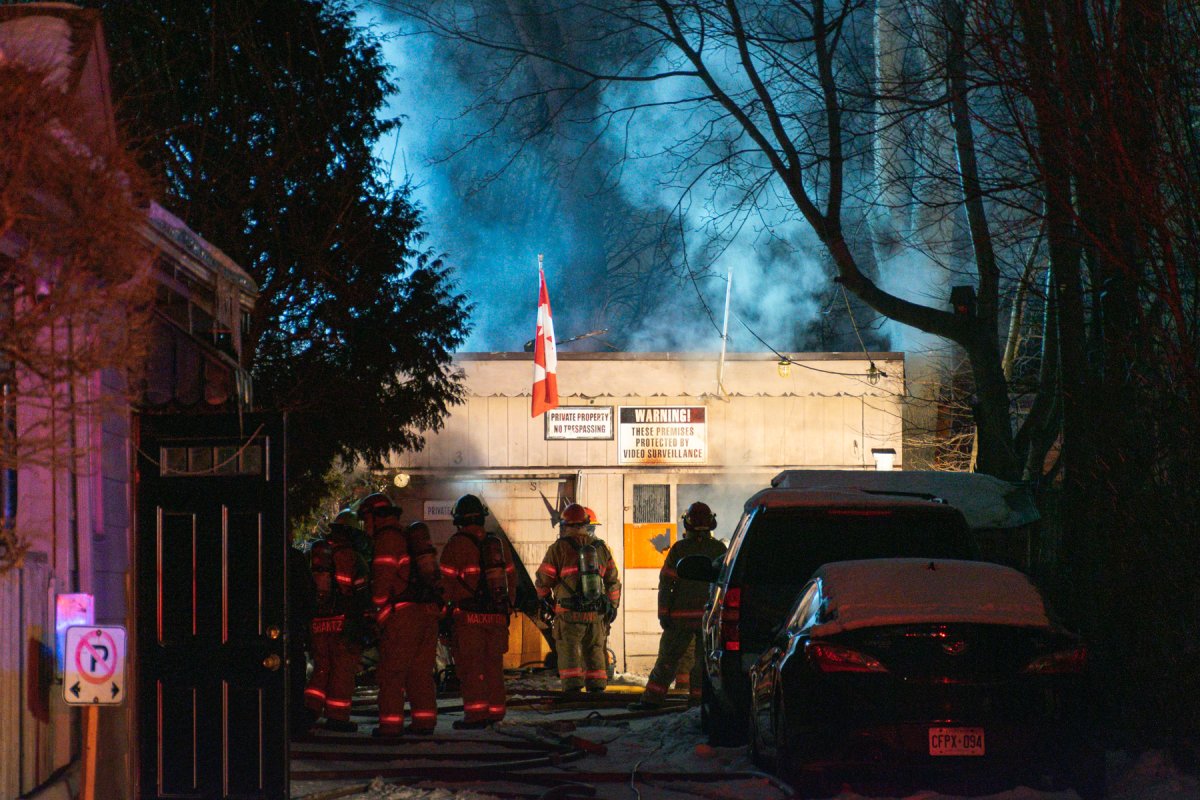 Fire crews work to extinguish a fire in a detached garage at 752 William St., in London, Ont., on February 8, 2021.