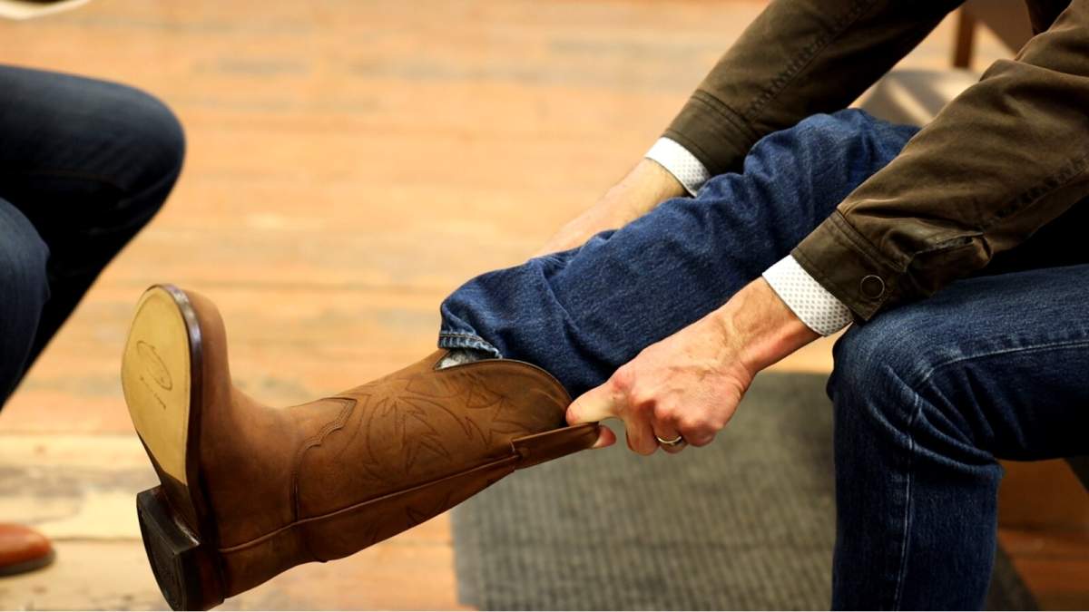 Minister of Finance Travis Toews purchases new boots at the Alberta Boot Company in Calgary for Budget 2021.