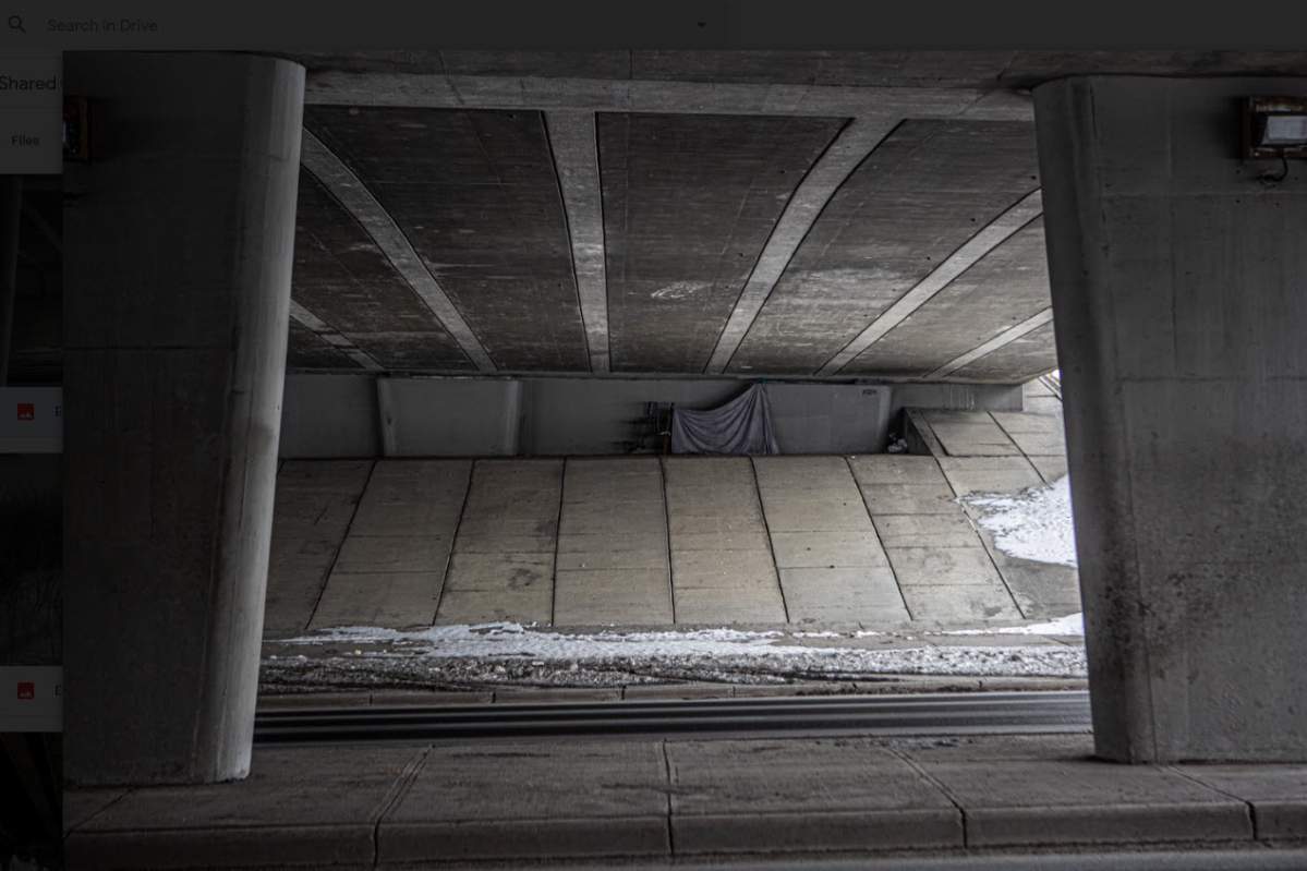 Sleeping under overpass (COURTESY: Alex Ramadan)