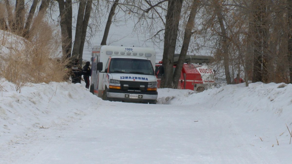 Saskatoon police along with, fire crews and paramedics on the scene of a body found in the river on Saturday.