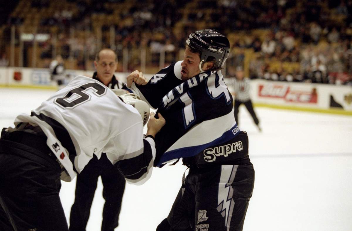 Rightwinger Brantt Myhres of the Tampa Bay Lightning in action against defenseman Sean O”Donnell of the Los Angeles Kings on December 5,1996.