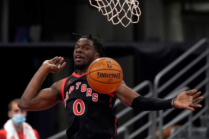 Toronto Raptors guard Terence Davis (0) follows through on a dunk against the Miami Heat during the first half of an NBA basketball game Wednesday, Jan. 20, 2021, in Tampa, Fla. 