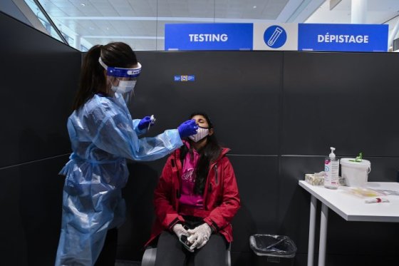 Woman receives COVID-19 test at Pearson International ariport.