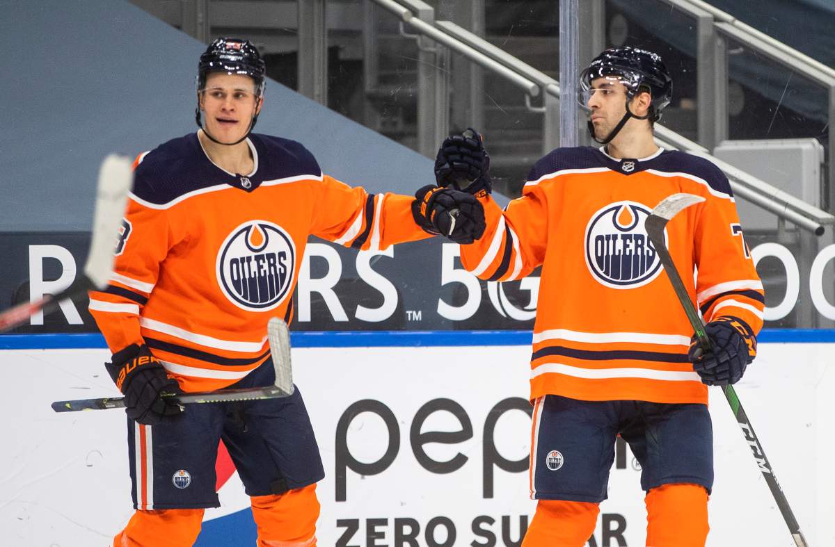 Edmonton Oilers' Jesse Puljujarvi (13) and Evan Bouchard (75) celebrate a goal against the Ottawa Senators during second period NHL action in Edmonton on Tuesday, February 2, 2021. THE CANADIAN PRESS/Jason Franson.