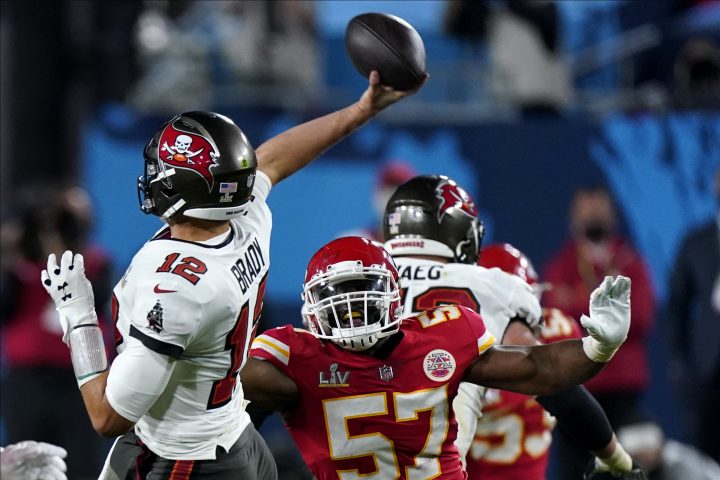 Tampa Bay Buccaneers Tom Brady passes under pressure from Kansas City Chiefs defensive end Alex Okafor during the second half of the NFL Super Bowl 55 football game, Sunday, Feb. 7, 2021, in Tampa, Fla.