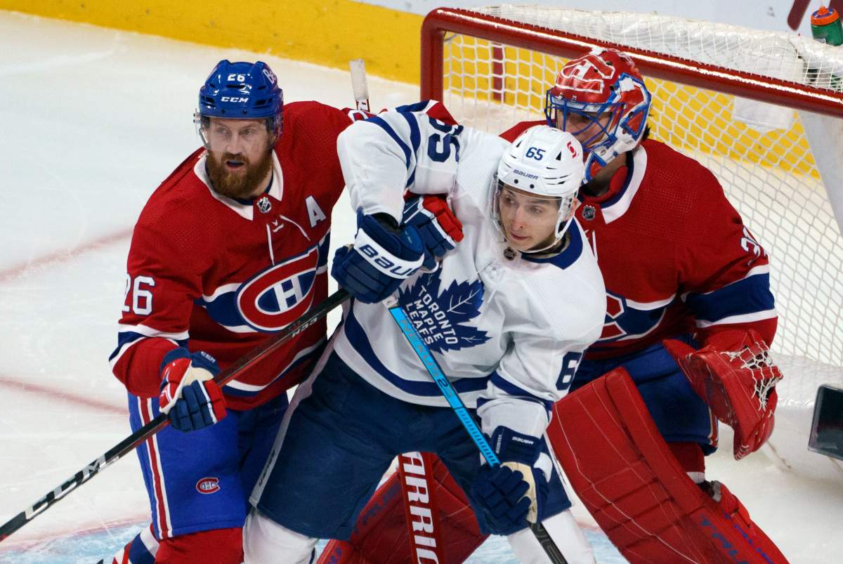 Montreal Canadiens defenceman Jeff Petry battles with Toronto Maple Leafs' Ilya Mikheyev in front of goaltender Carey Price during first period NHL hockey action in Montreal on Wednesday, February 10, 2021. THE CANADIAN PRESS/Paul Chiasson.