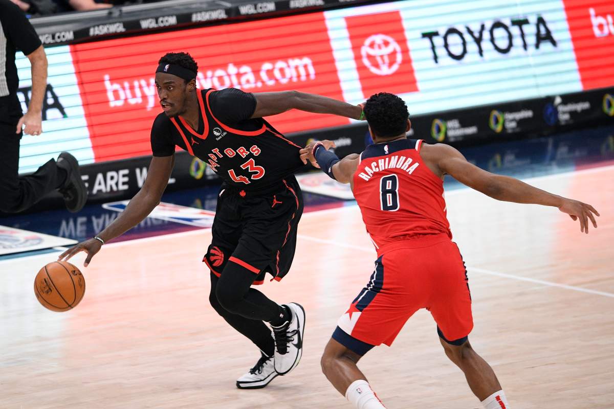 Toronto Raptors forward Pascal Siakam (43) dribbles the ball past Washington Wizards forward Rui Hachimura (8), of Japan, during the second half of an NBA basketball game, Wednesday, Feb. 10, 2021, in Washington. The Raptors won 137-115. 