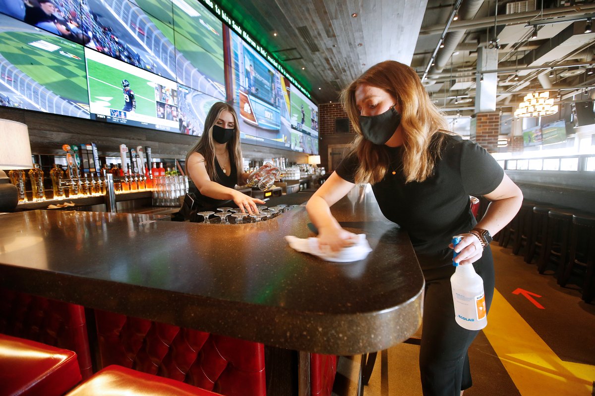 Browns Socialhouse bar manager, Jaz Hrem, left, and server Claire McCarvill set up the bar in preparation of re-opening as some COVID-19 restrictions are lifted in Winnipeg, Friday, February 12, 2021.