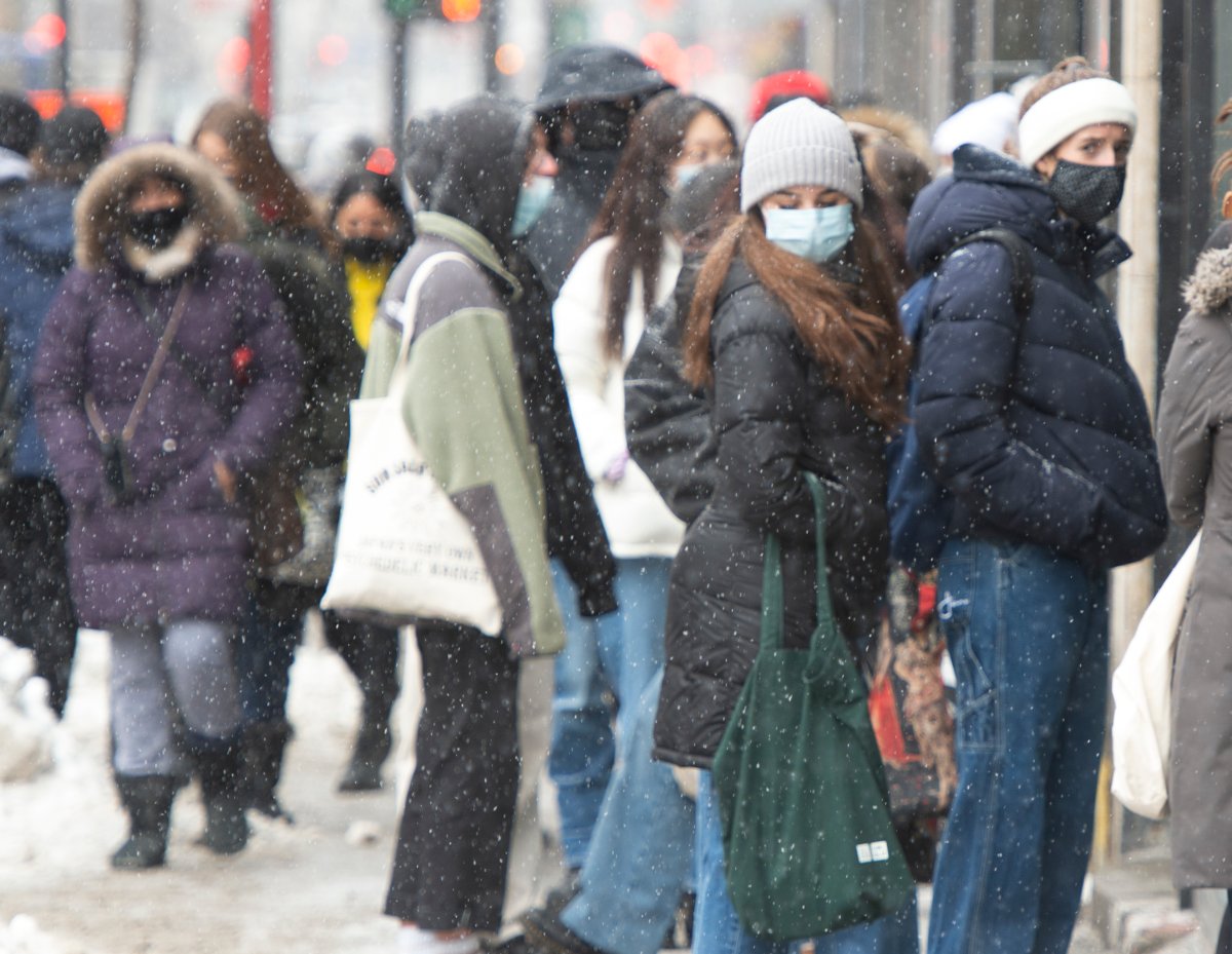 Customers line up at a store, Monday, Feb. 15, 2021 in Montreal.
