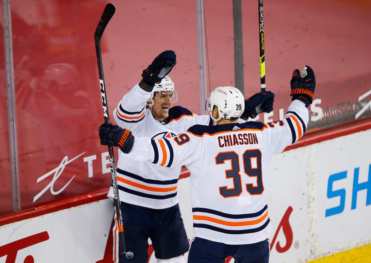 Edmonton Oilers' Gaetan Haas (L) celebrates his goal with teammate Alex Chiasson against the Calgary Flames during the second period of their NHL hockey game in Calgary, Friday, Feb. 19, 2021.THE CANADIAN PRESS/Todd Korol.