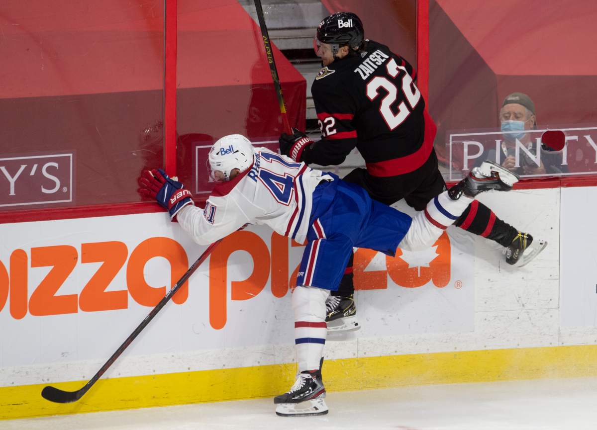 Ottawa Senators defenceman Nikita Zaitsev (22) and Montreal Canadiens left wing Paul Byron Montreal Canadiens left wing Paul Byron (41) collide along the boards
during second period NHL action Sunday February 21, 2021 in Ottawa. 