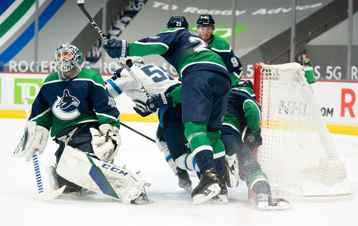Winnipeg Jets centre Mark Scheifele (55) celebrates his goal past Vancouver Canucks goaltender Braden Holtby (49) during third period NHL action in Vancouver, Sunday, February 21, 2021.
