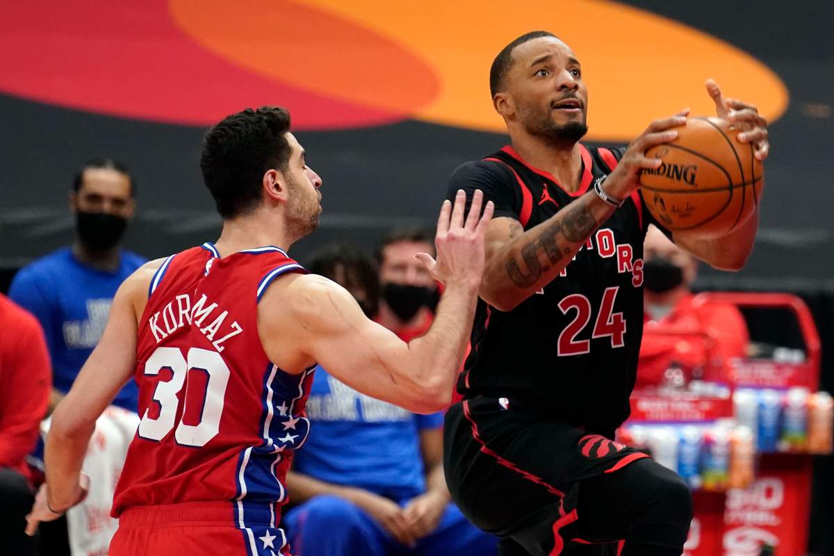 Toronto Raptors guard Norman Powell (24) goes to the basket ahead of Philadelphia 76ers guard Furkan Korkmaz (30) during the second half of an NBA basketball game Tuesday, Feb. 23, 2021, in Tampa, Fla.
