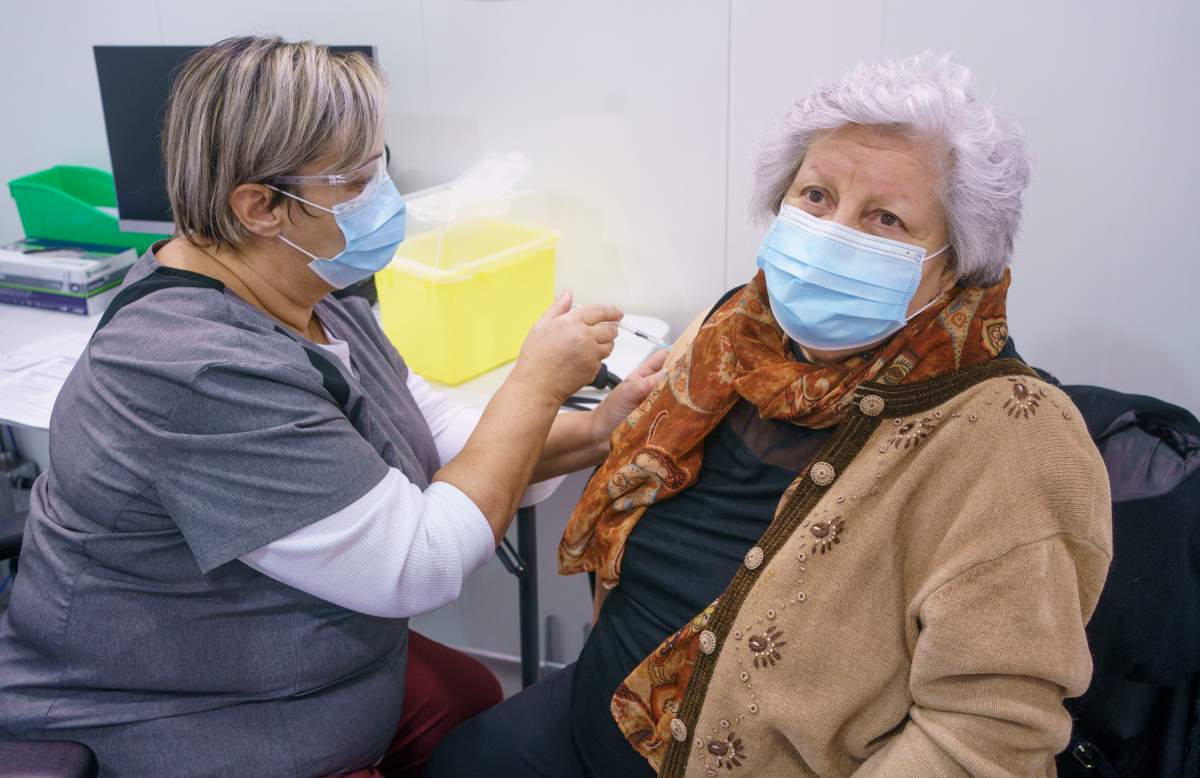 Maria Levita receives her first dose of COVID-19 vaccination in Laval, Que. on Thursday, February 25, 2021, marking the start of mass vaccination in the province of Quebec. 