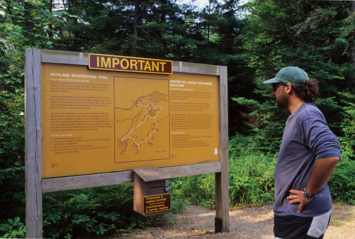 A man checks out a trail map in Ontario's Algonquin Park in this undated handout photo. Ontario Parks says that reservations for its campsites have nearly doubled since the same time last year.