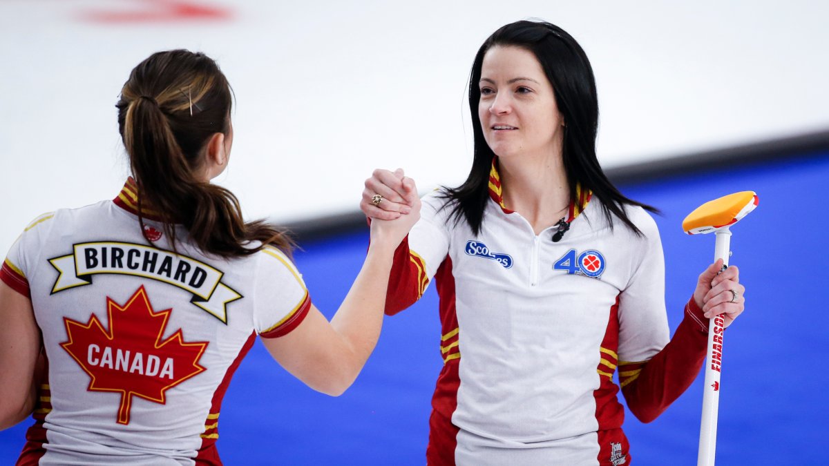 Team Canada skip Kerri Einarson, right, and second Shannon Birchard celebrate  after defeating Team Alberta in the semi-final at the Scotties Tournament of Hearts in Calgary, Alta., Sunday, Feb. 28, 2021.