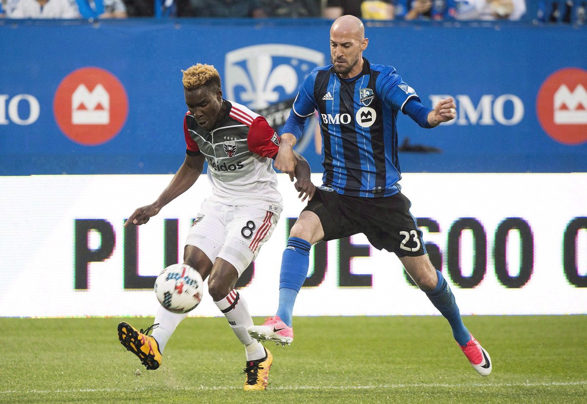Montreal Impact's Laurent Ciman, right, challenges D.C. United's Lloyd Sam during second half MLS soccer action in Montreal, Saturday, July 1, 2017. 