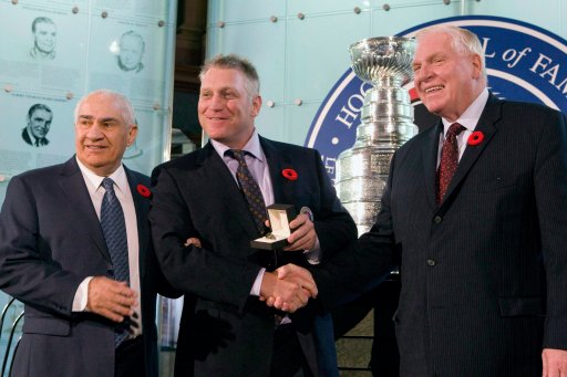 Hockey Hall of Fame Selection Committee Co-Chair Jim Gregory (left) looks on as Chairman Bill Hay (right) presents Brett Hull with his ring in a ceremony at the Hockey Hall of Fame in Toronto on Monday, November 9, 2009.