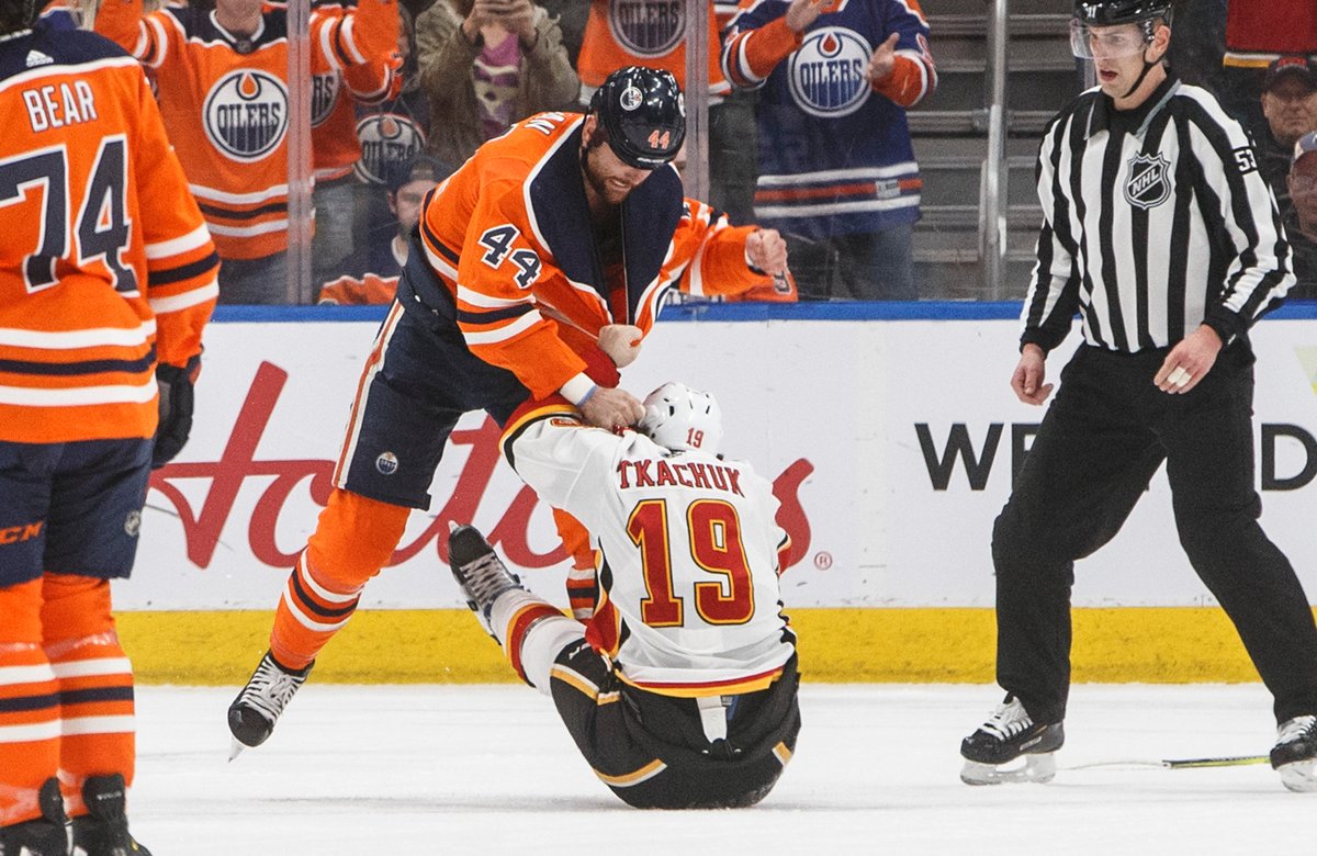 Calgary Flames' Matthew Tkachuk (19) and Edmonton Oilers' Zack Kassian (44) fight during first period NHL action in Edmonton, Alta., on Wednesday January 29, 2020. THE CANADIAN PRESS/Jason Franson.