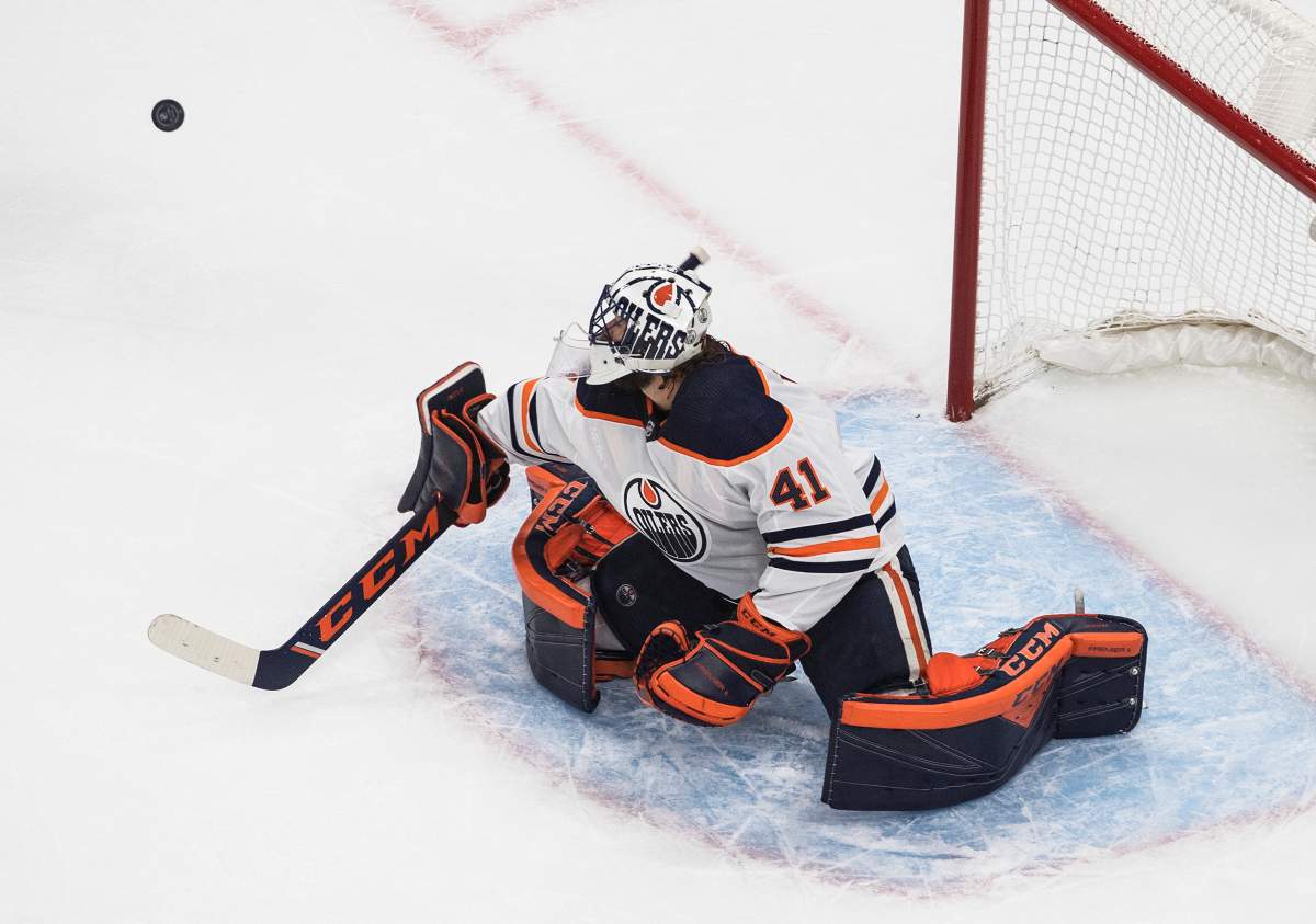 Edmonton Oilers goalie Mike Smith (41) makes the save against the Calgary Flames during second period NHL exhibition game action in Edmonton on Tuesday, July 28, 2020. THE CANADIAN PRESS/Jason Franson.