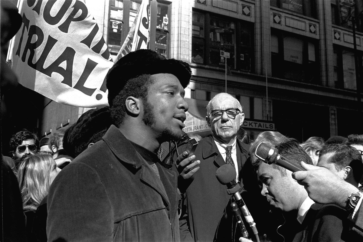 FILE - In this Oct. 29, 1969, file photo, Fred Hampton, center, chairman of the Illinois Black Panther party, speaks outside a rally outside the U.S. Courthouse in Chicago while Dr. Benjamin Spock, background, listens. 